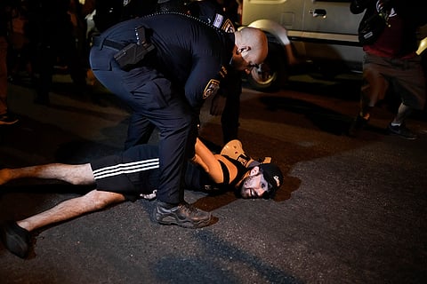 Israel-Hamas war: Israeli police officers detain a demonstrator in Jerusalem